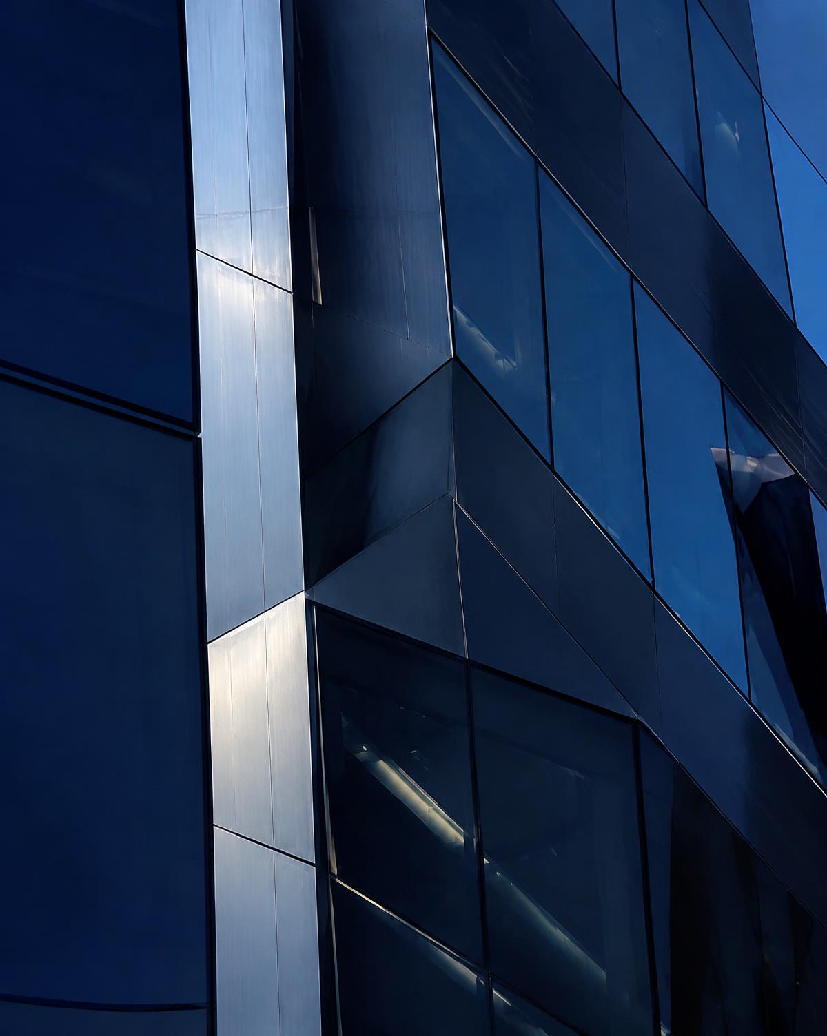 Glass and steel skyscraper facade at blue hour